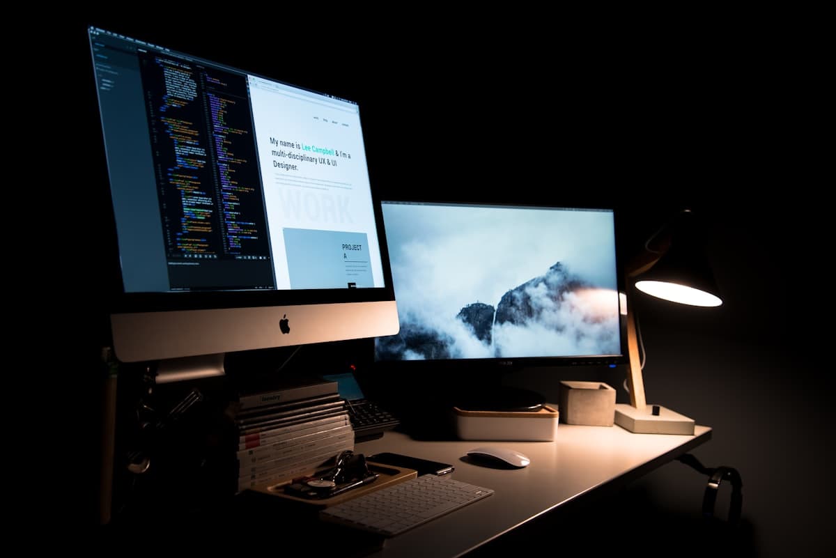 Web design team working on a custom responsive website displayed across multiple screens, showing the process of building a fast, mobile-first business website